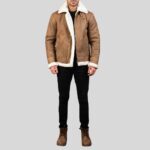 vollansicht eines mannes in brauner shearling jacke mit weißem lammfellkragen, schwarzer jeans und braunen boots